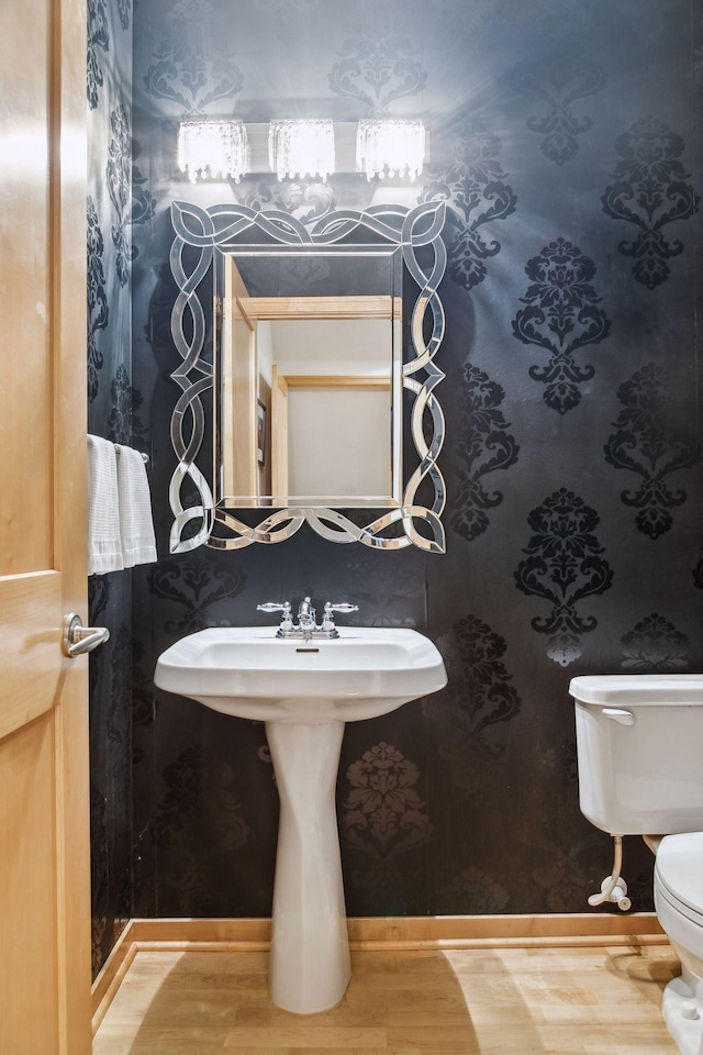 187 Sherman St, Saint Paul, MN 55102 - half bath with toilet, wood finished floors, and a sink