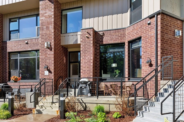 187 Sherman St, Saint Paul, MN 55102 - doorway to property featuring brick siding and board and batten siding