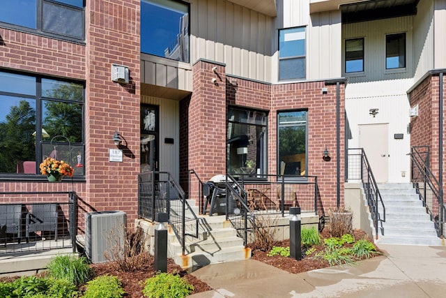 187 Sherman St, Saint Paul, MN 55102 - doorway to property with brick siding and cooling unit