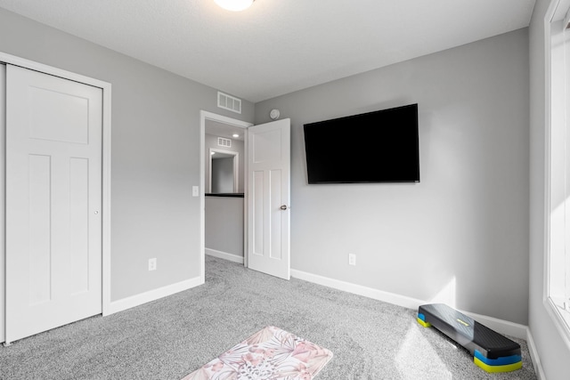 unfurnished bedroom featuring carpet flooring and a closet