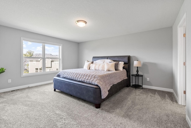 carpeted bedroom featuring a textured ceiling