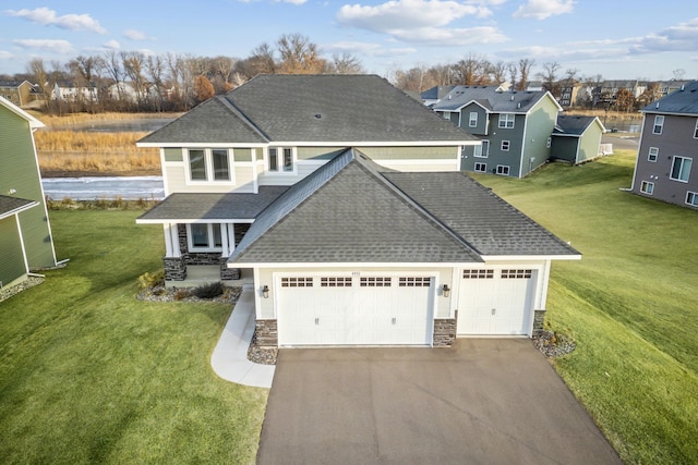 view of front of house featuring a front lawn and a garage