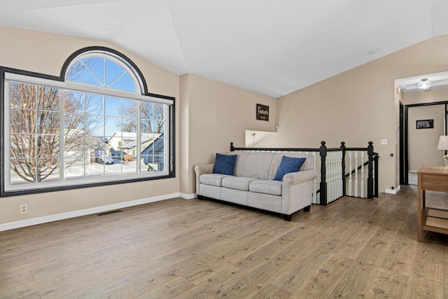 living room featuring vaulted ceiling and light hardwood / wood-style floors