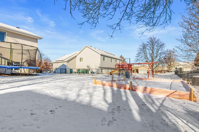 back of property with a playground and a trampoline