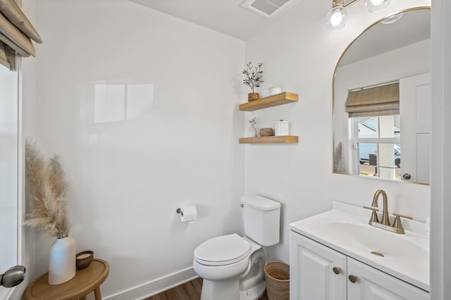 bathroom with vanity, toilet, and wood-type flooring