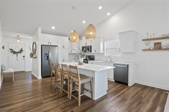 kitchen featuring pendant lighting, sink, white cabinetry, and stainless steel appliances