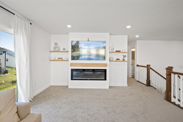 carpeted living room featuring a textured ceiling