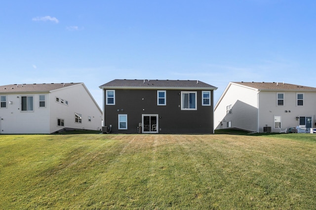 back of house featuring central AC and a lawn