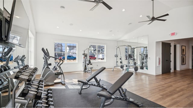 gym with ceiling fan, wood-type flooring, and lofted ceiling