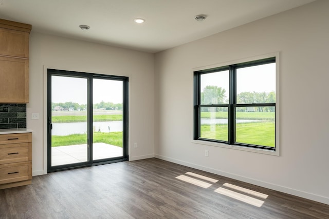 unfurnished room with hardwood / wood-style flooring