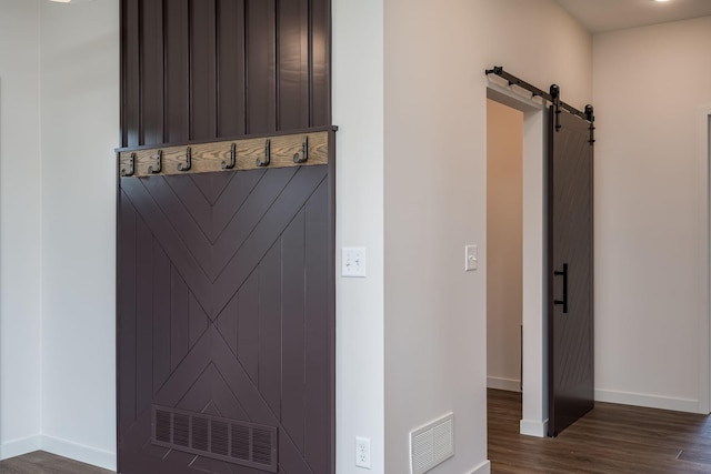 interior space featuring dark hardwood / wood-style flooring and a barn door