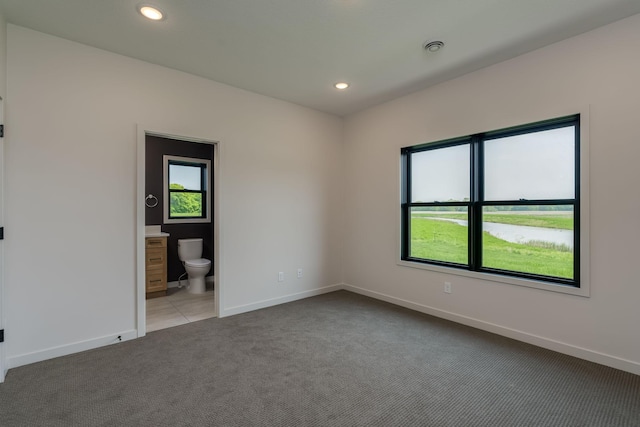 unfurnished room featuring light colored carpet