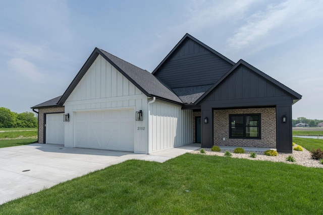 view of front of home with a garage and a front lawn