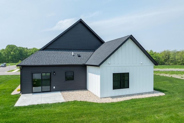 rear view of property with a lawn and a patio area