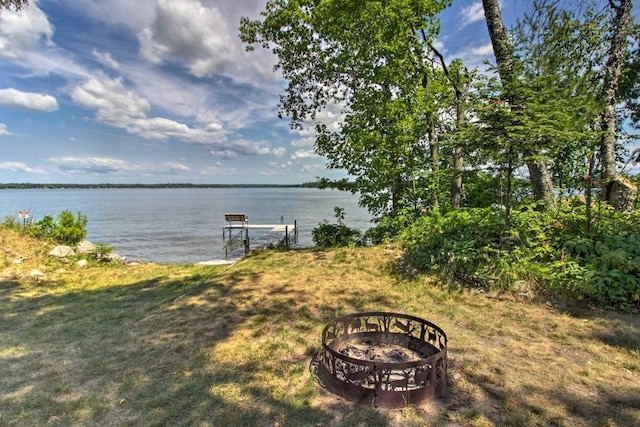 view of yard featuring a water view and a fire pit