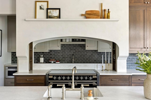 kitchen with decorative backsplash, sink, and appliances with stainless steel finishes