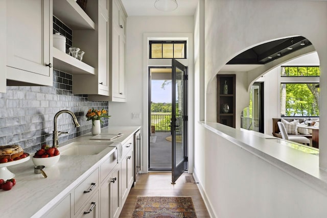 kitchen featuring white cabinets, sink, and a wealth of natural light