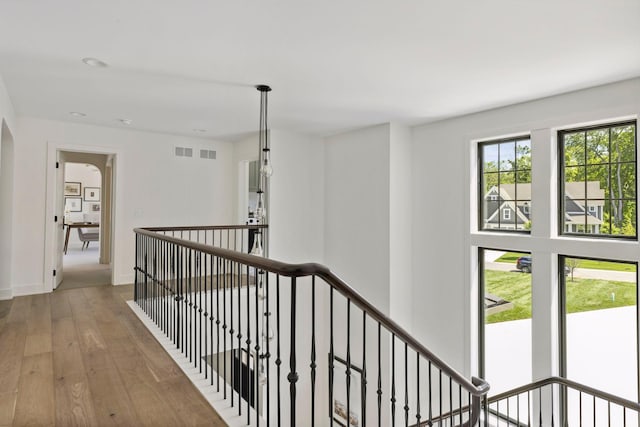 hallway with hardwood / wood-style flooring