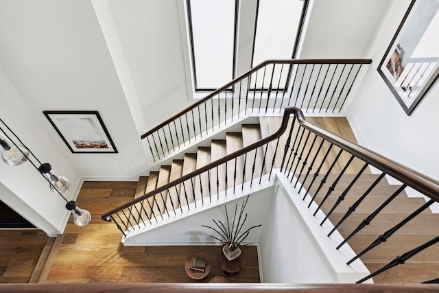 stairway with hardwood / wood-style flooring