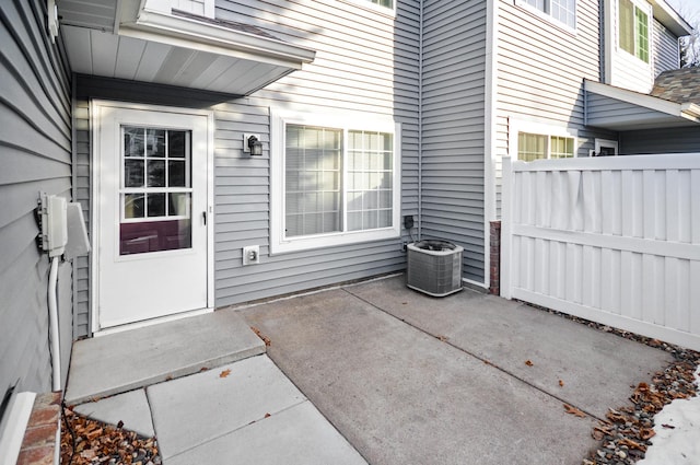 doorway to property featuring central air condition unit and a patio area