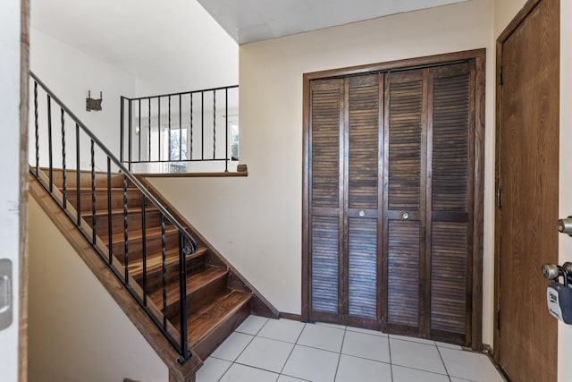 stairs featuring tile patterned floors