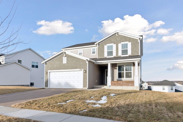 view of front facade with a front yard and a garage