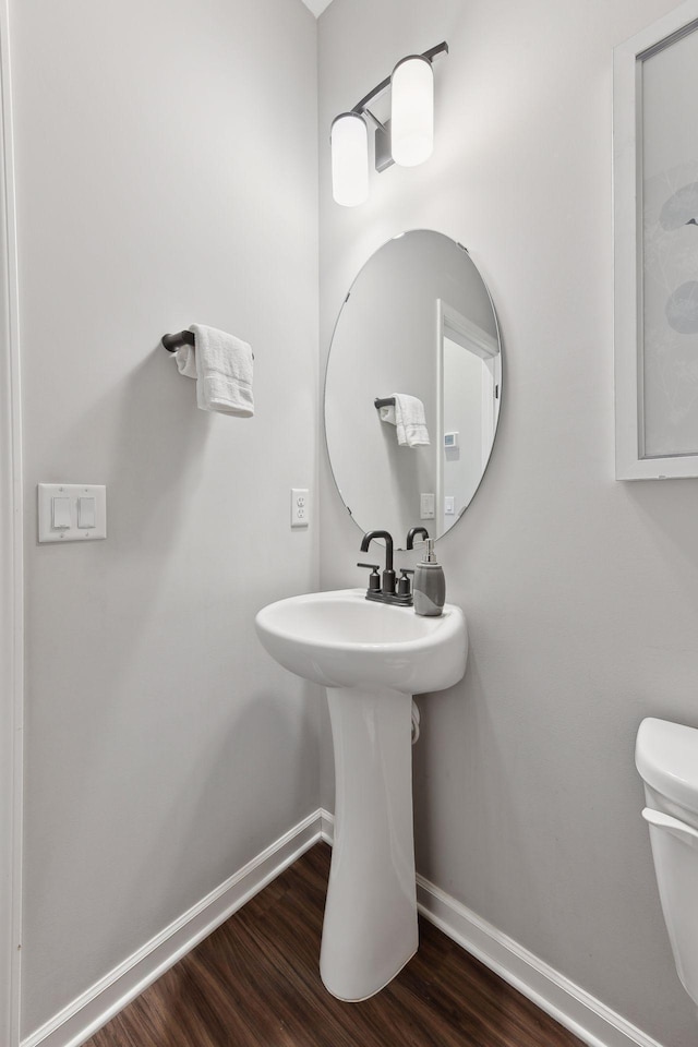 bathroom featuring hardwood / wood-style flooring and toilet