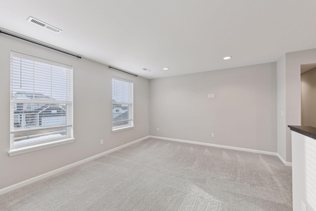 empty room with light colored carpet