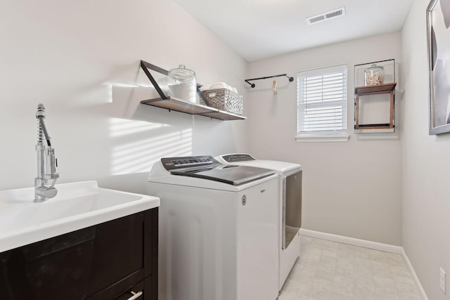 laundry area featuring independent washer and dryer and sink