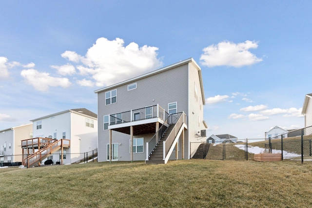 back of house featuring a yard and a wooden deck