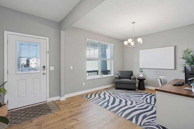 entrance foyer with a chandelier, wood finished floors, beam ceiling, and baseboards