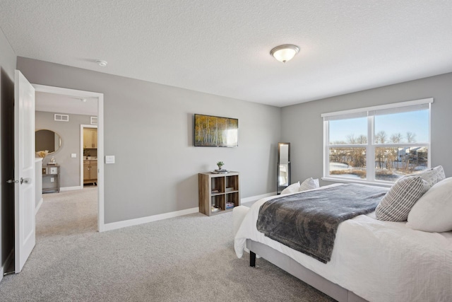 bedroom with visible vents, light carpet, baseboards, and a textured ceiling