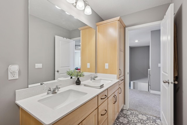 bathroom with a sink, baseboards, and double vanity