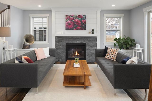 living room featuring plenty of natural light, a fireplace, and light hardwood / wood-style flooring