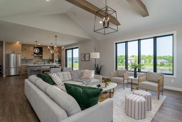 living room featuring sink, high vaulted ceiling, beamed ceiling, a chandelier, and light hardwood / wood-style floors