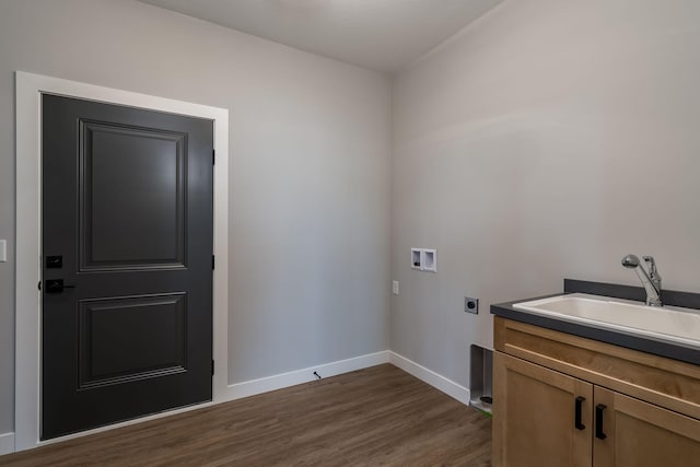 clothes washing area with cabinets, hookup for a washing machine, electric dryer hookup, sink, and dark hardwood / wood-style floors