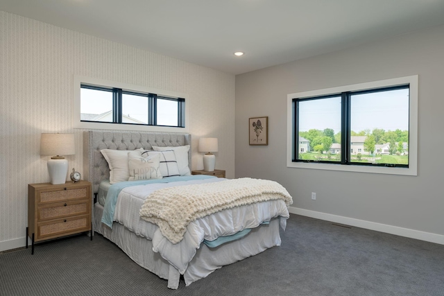 carpeted bedroom with multiple windows