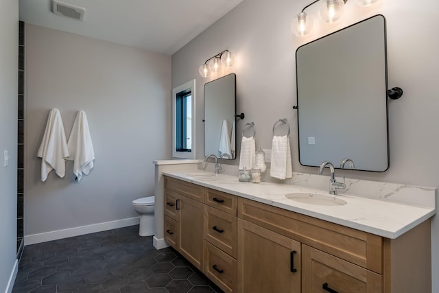 bathroom with tile patterned floors, vanity, and toilet