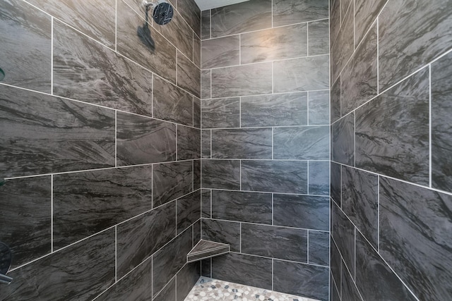 bathroom with a tile shower