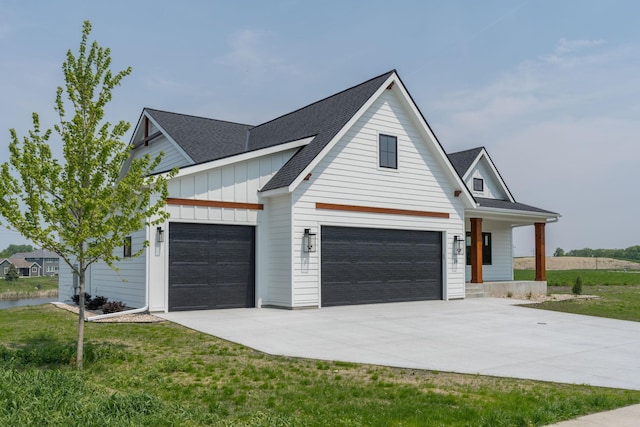 modern farmhouse with a front yard, a porch, and a garage