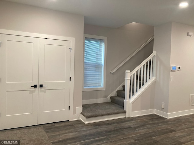 entryway with dark hardwood / wood-style flooring