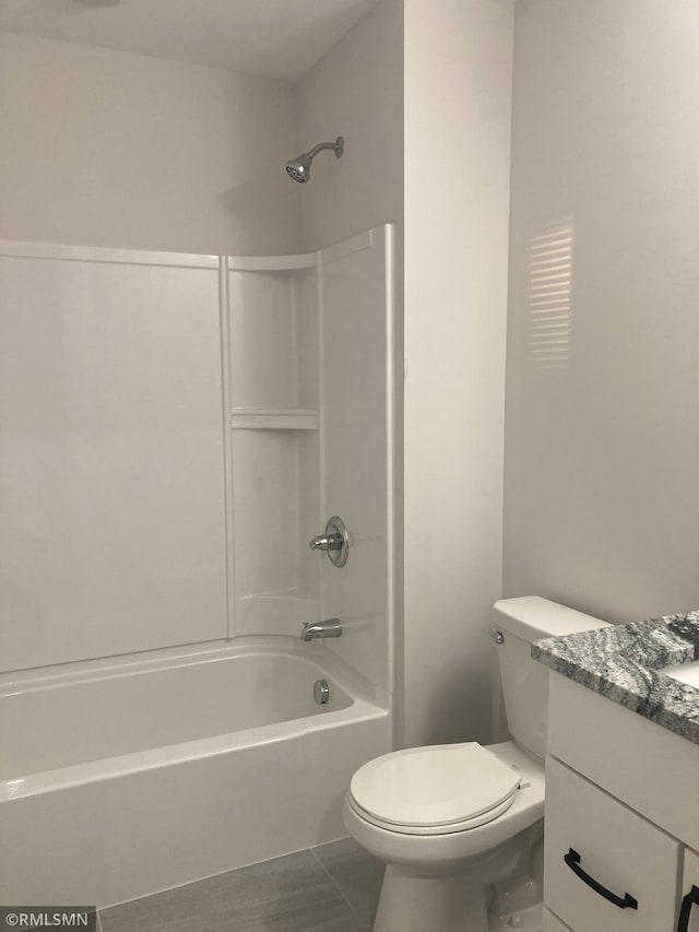 full bathroom with bathing tub / shower combination, vanity, and toilet