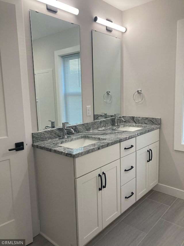 bathroom featuring tile patterned flooring and vanity