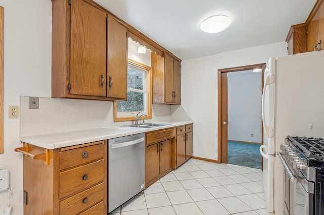 kitchen with sink, light tile patterned floors, and stainless steel appliances