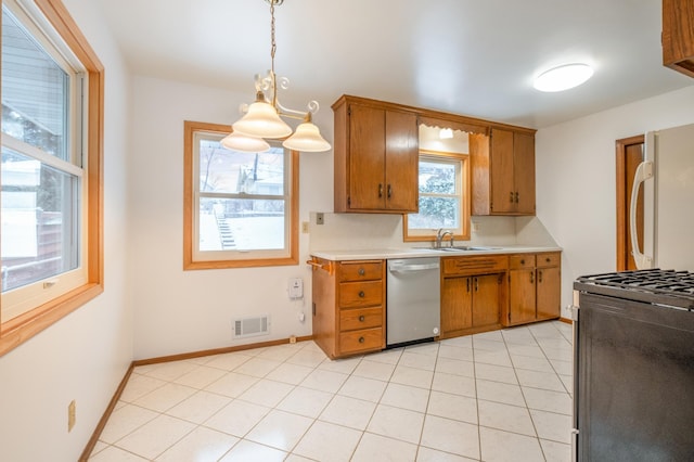 kitchen featuring sink, hanging light fixtures, stainless steel dishwasher, stove, and fridge