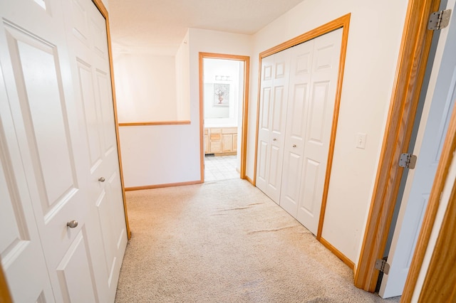 corridor with light carpet