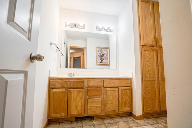 bathroom featuring vanity and a textured ceiling