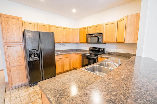 kitchen with sink, kitchen peninsula, light brown cabinetry, and black appliances