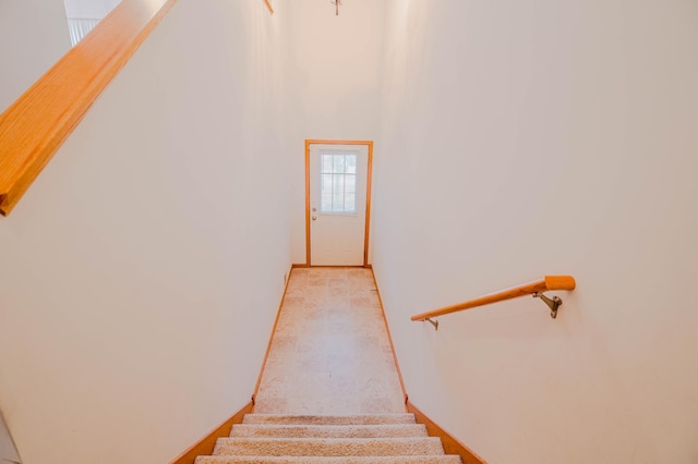 stairs featuring a towering ceiling