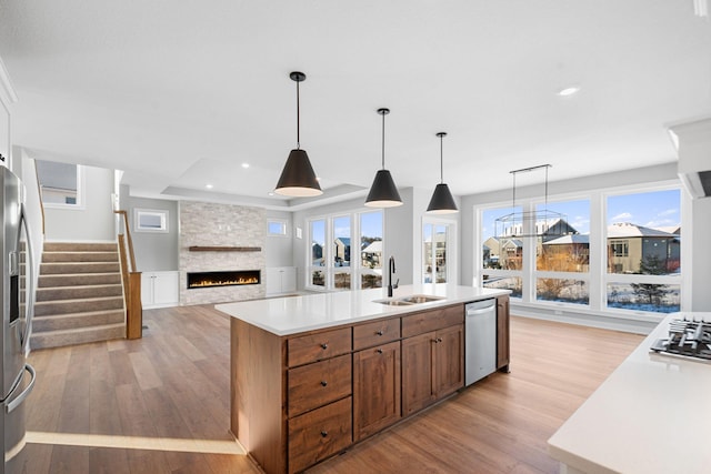 kitchen featuring sink, a center island with sink, pendant lighting, and stainless steel appliances